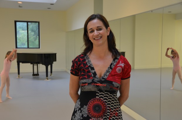 Martha Hicks poses in one of her new studios featuring a grand piano since her ballet and creative movement classes are accompanied by live music.